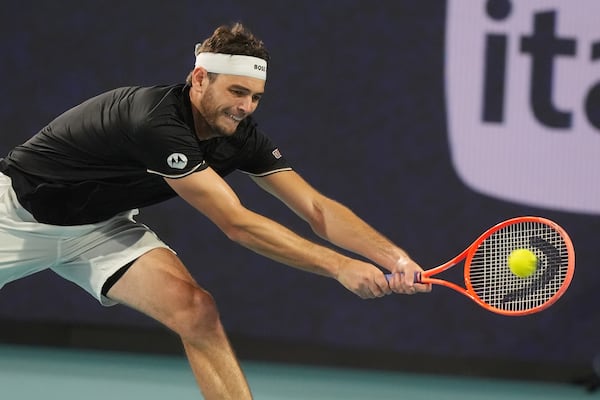 Taylor Fritz returns a hit to Jakub Mensik of the Czech Republic during a semifinal match at the Miami Open tennis tournament, Friday, March 28, 2025, in Miami Gardens, Fla. (AP Photo/Marta Lavandier)