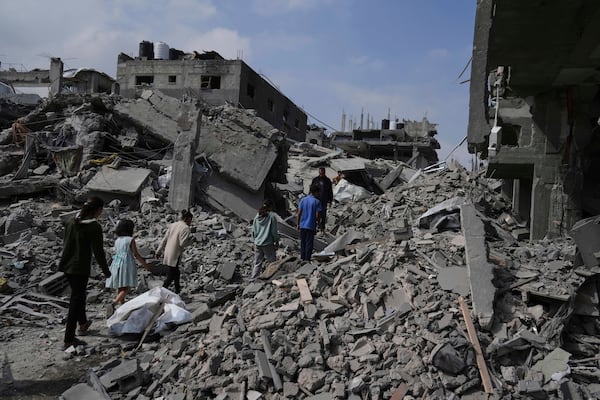 Palestinians walk in the rubbles after an Israeli army airstrike in Beit Lahia, northern Gaza Strip, Monday, April 28, 2025. (AP Photo/Jehad Alshrafi)