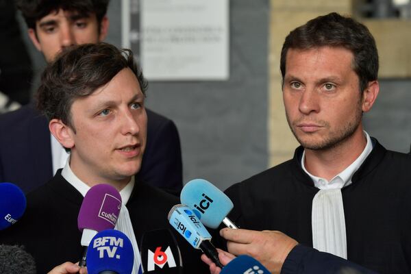 Maxime Tessier, left, and Thibaut Kurzawa, Joel Le Scouarnec's lawyers, answer reporters after the 74-year-old pedophile and former surgeon who raped hundreds of victims over a period spanning more than two decades was given a maximum 20-year prison sentence Wednesday, May 28, 2025 in Vannes, Brittany, western France. (AP Photo/Mathieu Pattier)