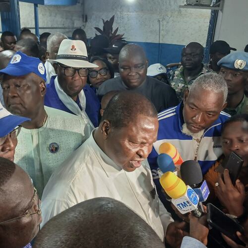 Central African Republic President Faustin Archange Touadéra, bottom center, speaks to the media after being declared the winner of the presidential election in Bangui, Central African Republic, Monday, Jan. 5, 2026. (AP Photo/Jean-Fernand Koena)
