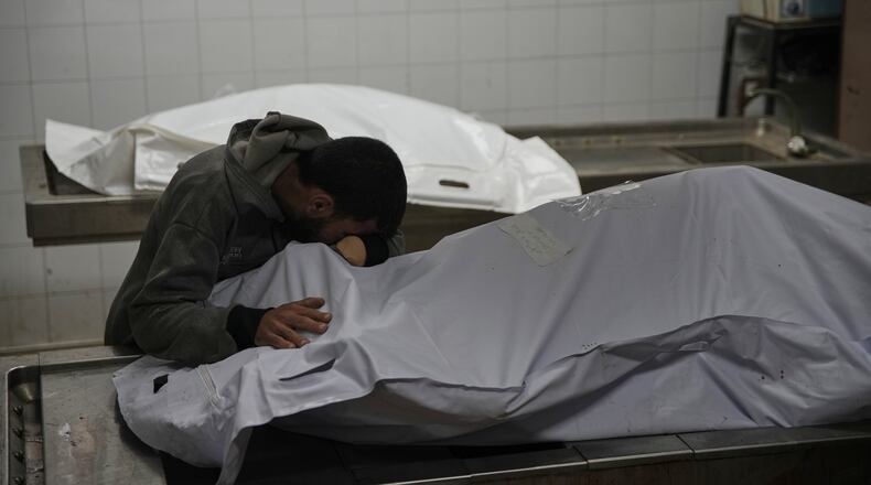 Magdi Abu Al-Khair bids farewell to his mother, Amal Abu Al-Khair, after she and her grandchild, Saud, were killed when their tent caught fire overnight at the Yarmouk displacement camp, at Al-Shifa Hospital in Gaza City, Friday, Jan. 2, 2026. (AP Photo/Jehad Alshrafi)