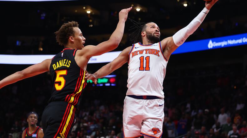 New York Knicks guard Jalen Brunson (11) shoots against Atlanta Hawks guard Dyson Daniels (5) during the second half of an NBA basketball game, Monday, April 6, 2026, in Atlanta. (AP Photo/Colin Hubbard)