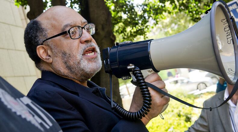 Then-senator Vincent Fort uses a bullhorn to speak to MARTA employees and retirees during union negotiations in front of the law offices of MARTA Board Chair Robbie Ashe on October 6, 2014, in Atlanta. JONATHAN PHILLIPS / SPECIAL