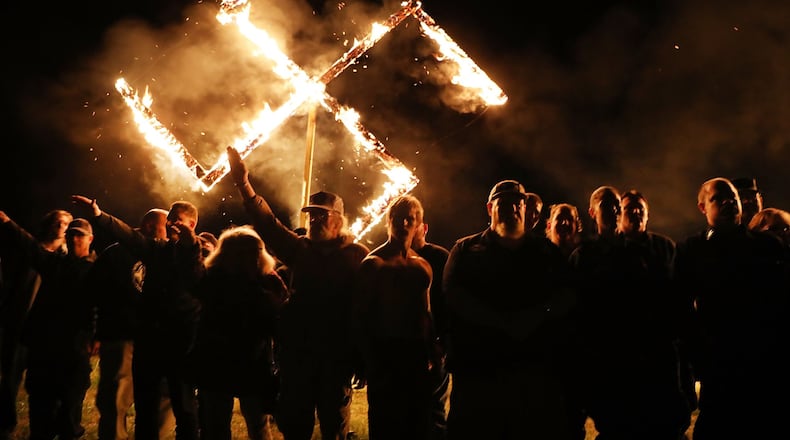 Members of the National Socialist Movement, a neo-Nazi group, hold a swastika-burning in Draketown, Ga., on April 21, 2018, following their rally that day in Newnan, Ga. (Photo by Spencer Platt/Getty Images)