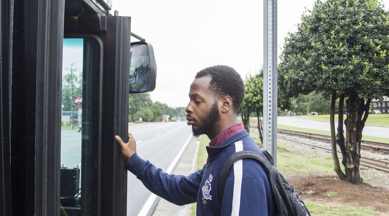 DeAngelo Bowie, 24, catches the bus to get to work. Bowie, 24, dropped out of Georgia State University in 2013 after a series of family health crises and financial problems derailed his dream of being a history teacher. Chad Rhym/ Chad.Rhym@ajc.com