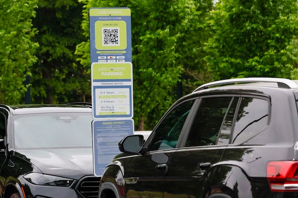 A sign at Lee + Wine Commercial District shows the parking rules and rates as seen on Sunday, April 19, 2026. (Miguel Martinez/AJC)