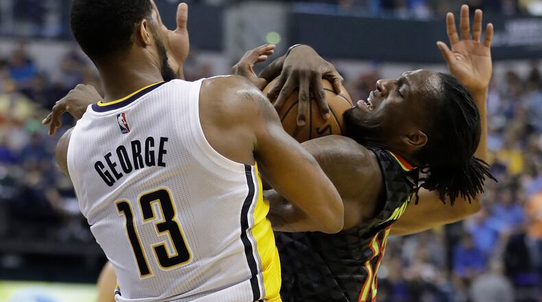Atlanta Hawks’ Taurean Prince is fouled by Indiana Pacers’ Paul George during the second half of an NBA basketball game Wednesday, April 12, 2017, in Indianapolis. Indiana defeated Atlanta 104-86. (AP Photo/Darron Cummings)