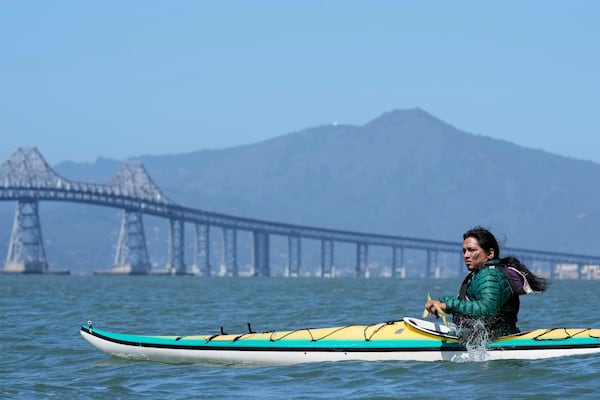 Juan Bay, president of the Waorani people of Ecuador, kayaks in the San Francisco Bay toward the Chevron Long Wharf, Thursday, June 19, 2025, in Richmond, Calif. (AP Photo/Godofredo A. Vásquez)