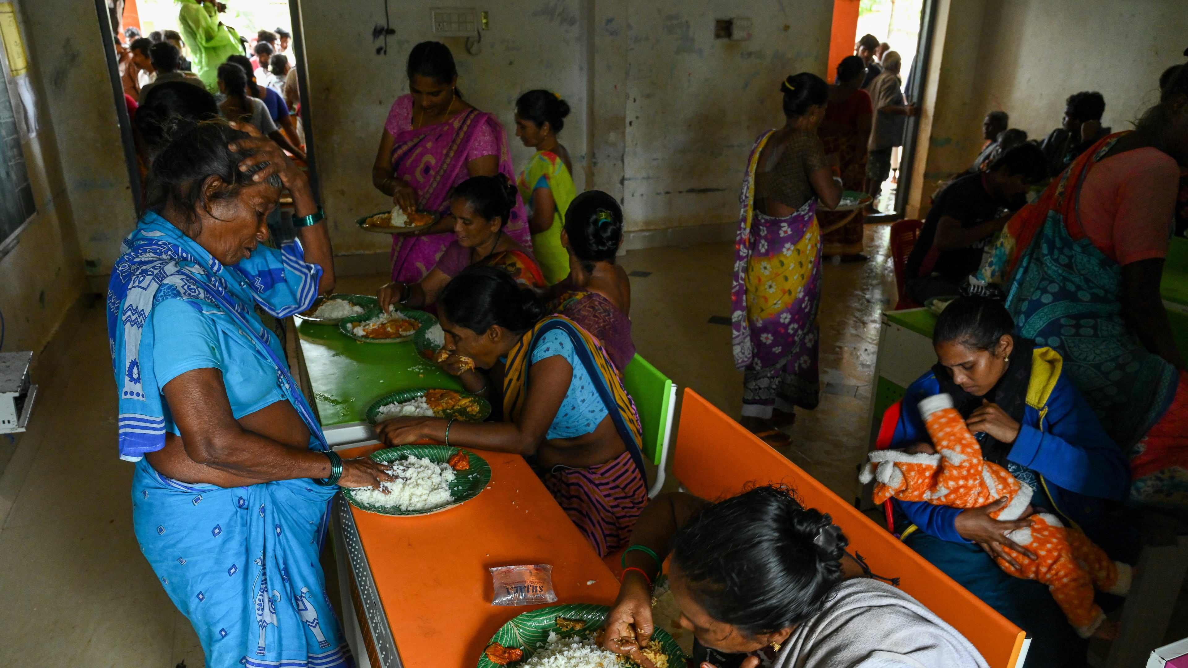 Evacuated Indian villagers of Uppada eat food in a temporary relief centre as Cyclone Montha, in Kakinada district of Andhra Pradesh, India, Tuesday, Oct. 28, 2025. (AP Photo)