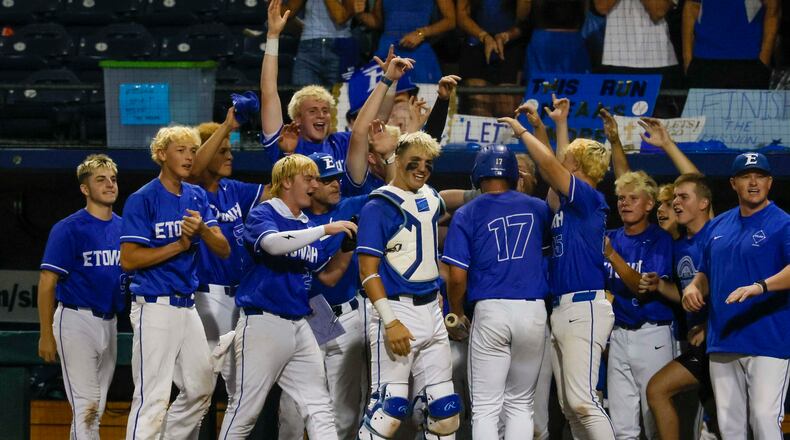 Etowah Eagles players celebrate with first baseman Carson Moore after he scores against North Paulding during the second inning of Game 1 of the Class 6A GHSA baseball finals at Gwinnett Field on Tuesday, May 26, 2026, in Lawrenceville, Ga. (Miguel Martinez/AJC)