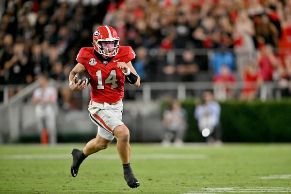 Georgia quarterback Gunner Stockton runs the ball during the second half against Alabama at Sanford Stadium on Saturday, Sept. 27, 2025, in Athens. The Bulldogs’ odds of making the 12-team CFP field took a hit with the 24-21 loss to Alabama. (Hyosub Shin/AJC)