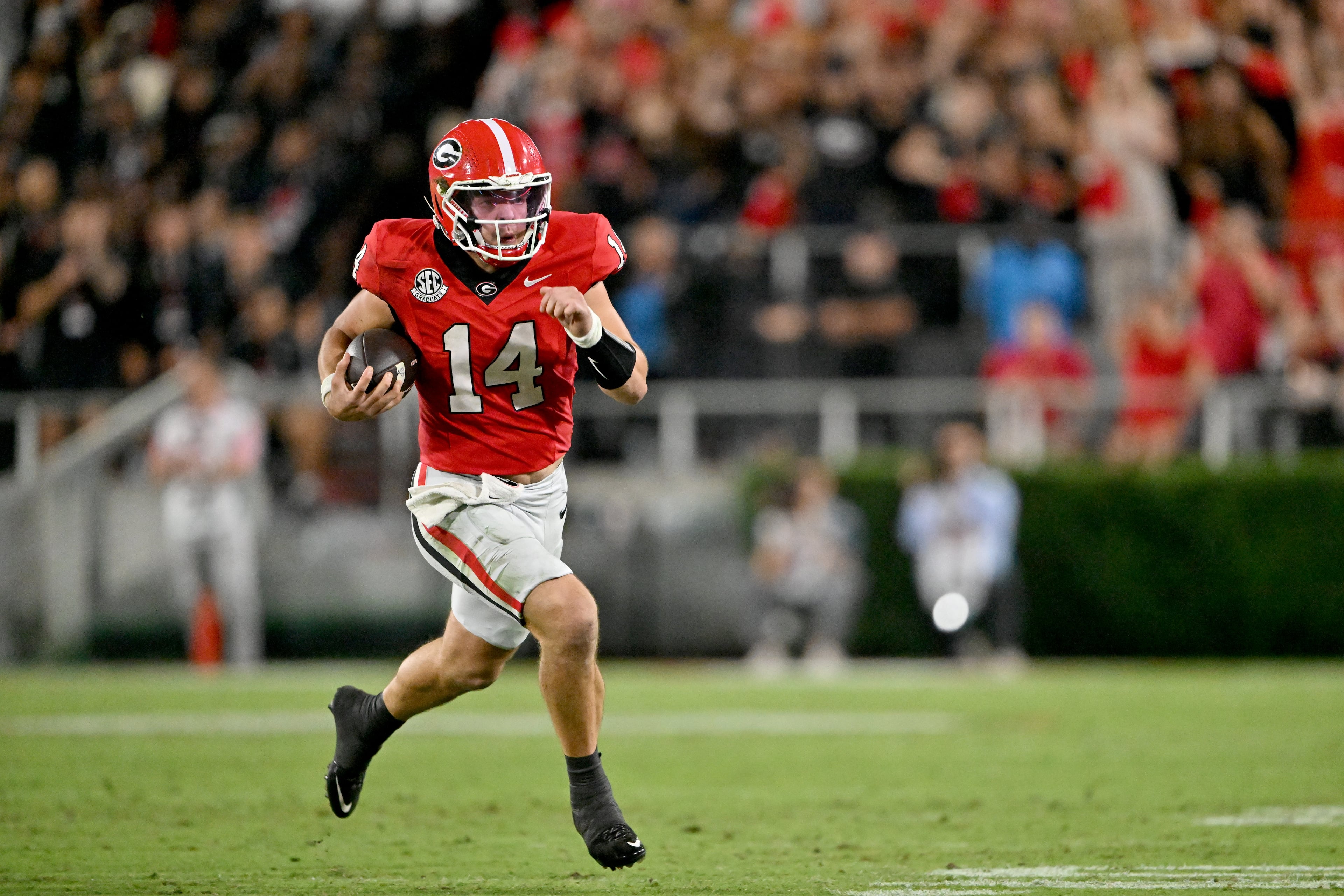 Georgia quarterback Gunner Stockton (14) runs the ball during the second half in an NCAA football game at Sanford Stadium, Saturday, September 27, 2025, in Athens. Alabama won 24-21 over Georgia. (Hyosub Shin / AJC)