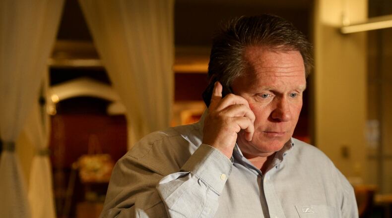 Bart Nye, President of Prime Time Party Equipment Rental Service in Dayton, Ohio, talks on the phone in his showroom. He was a near-victim of con artists pretending to be from the IRS and demanding immediate payment under threat of arrest.