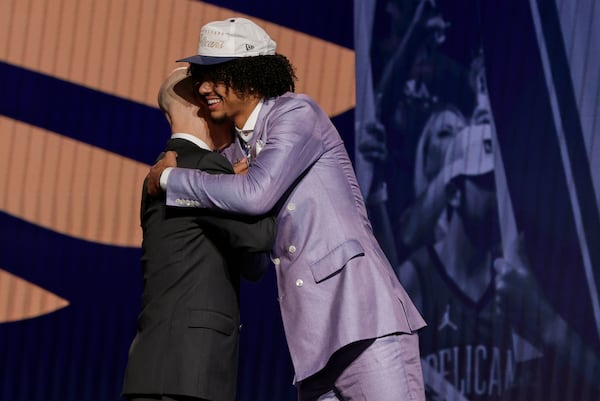 Asa Newell hugs NBA commissioner Adam Silver after being selected 23rd by the New Orleans Pelicans in the first round of the NBA basketball draft, Wednesday, June 25, 2025, in New York. (AP Photo/Adam Hunger)