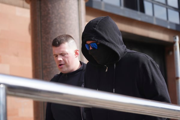 Adam Carruthers, right, arrives at Newcastle Crown Court where he is accused of criminal damage after the felling of the Sycamore Gap tree - valued at £622,000 and £1,114 damage to Hadrian's Wall, in Newcastle, England, Monday April 28, 2025. (Owen Humphreys/PA via AP)