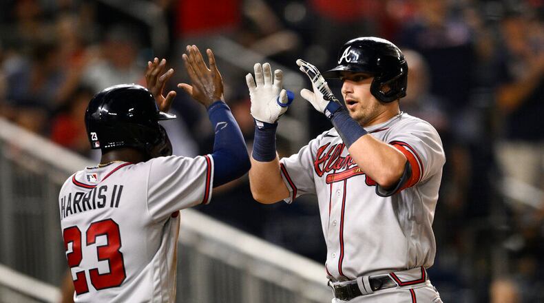 Atlanta's Austin Riley (right) celebrates his two-run home run with Michael Harris during the eighth inning against the Nationals on Wednesday night. The Braves won 8-2, their 14th consecutive victory. (AP Photo/Nick Wass)