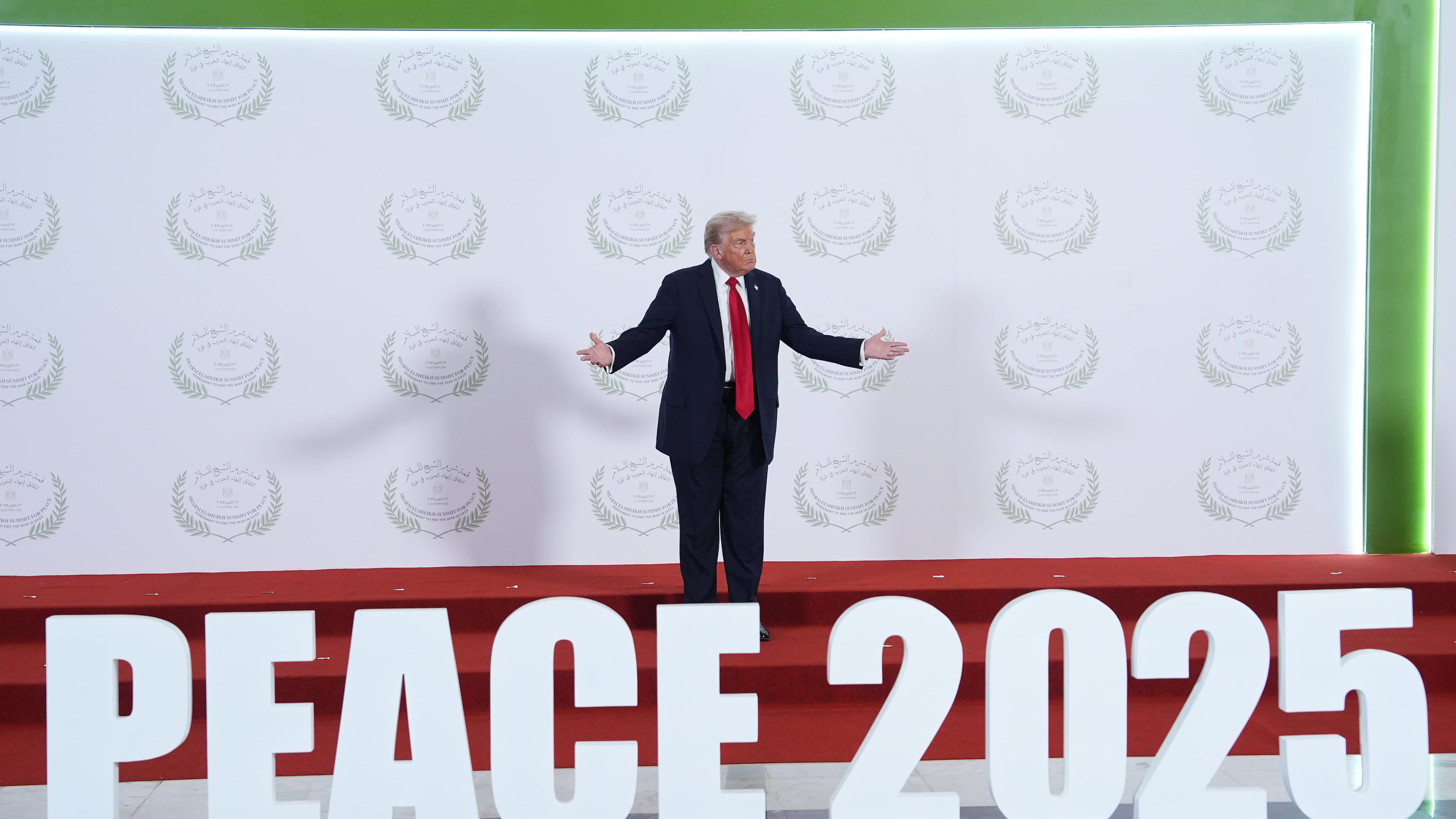 President Donald Trump waits to greet leaders during a summit to support ending the more than two-year Israel-Hamas war in Gaza after a breakthrough ceasefire deal, Monday, Oct. 13, 2025, in Sharm El Sheikh, Egypt. (AP Photo/Evan Vucci, Pool)