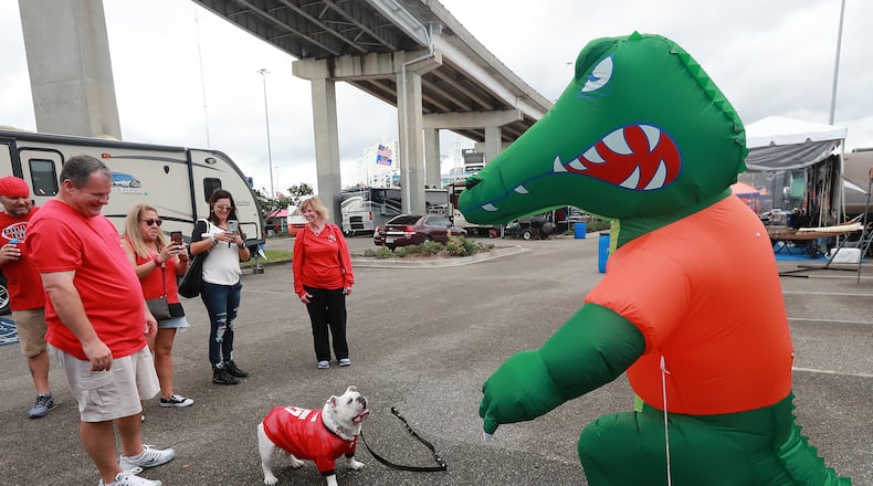 Sugar, a bulldog owned by Georgia fans, faces off with a Florida Gator before the 2018 game. Curtis Compton/ccompton@ajc.com