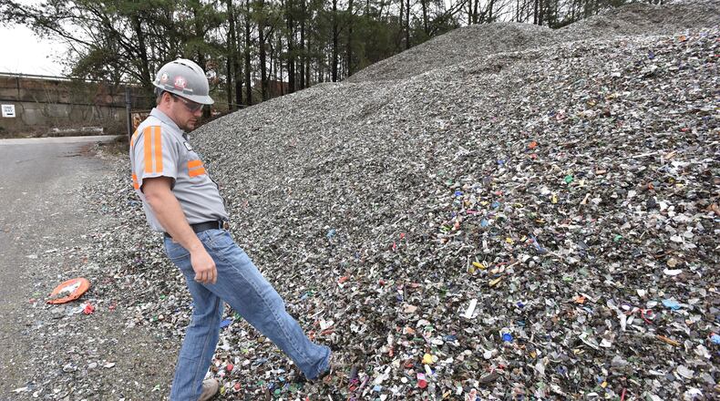 Plant Manager Tom Fletcher shows mixed recyclable materials at Strategic Materials recycling facility in College Park on Dec. 22, 2015. HYOSUB SHIN / HSHIN@AJC.COM