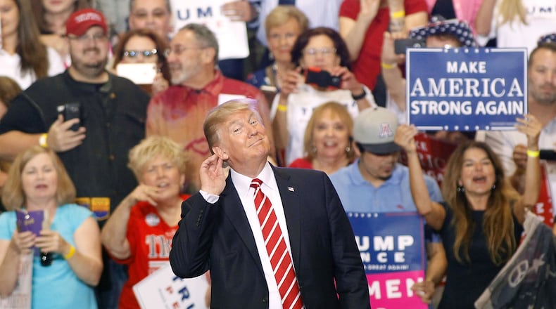 President Donald Trump encourages chants during a rally at the Phoenix Convention Center on Tuesday. Ralph Freso/Getty Images