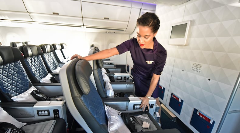 Danette Coombs, flight attendant, shows Delta's Airbus A350 Premium Select seat. (Hyosub Shin/Atlanta Journal-Constitution/TNS)