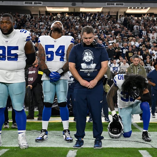 Dallas Cowboys players Bryan Anger (5), Kenny Clark (95), Sam Williams (54), Marist Liufau (35) and Cowboys linebackers coach Dave Borgonzi pause during a moment of silence for teammate Marshawn Kneeland prior to an NFL football game against the Las Vegas Raiders Monday, Nov. 17, 2025, in Las Vegas, in memory of Kneeland who passed away earlier this month. (AP Photo/David Becker)