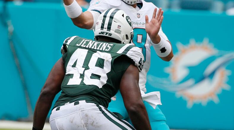 Miami Dolphins quarterback Matt Moore (8) throws under pressure from New York Jets outside linebacker Jordan Jenkins (48), during the first half of an NFL football game, Sunday, Oct. 22, 2017, in Miami Gardens, Fla. (AP Photo/Wilfredo Lee)
