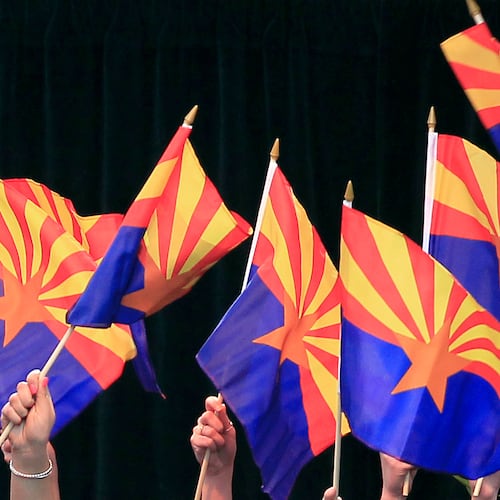 FILE - Members of the Arizona State University Barrett Choir wave Arizona state flags during the celebration of the 100th anniversary of Arizona's statehood, Feb. 14, 2012, in Phoenix.(AP Photo/Ross D. Franklin, File)