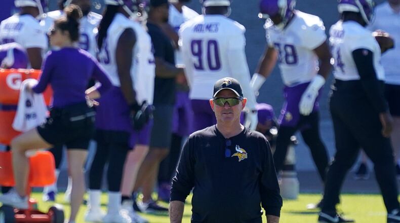 Minnesota Vikings head coach Mike Zimmer watches his players during the first day of mandatory minicamp in June in Eagan, Minnesota. Vikings assistant coach Rick Dennison was fired Friday for refusing to get the COVID-19 vaccine, which the NFL has made a requirement for all its top-level employees, according to a report by ESPN.