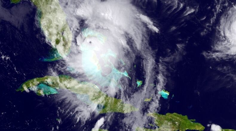 This GOES East satellite image posted at 5:12 p.m. and provided by the National Oceanic and Atmospheric Administration (NOAA), shows Hurricane Matthew moving northwest along the east coast of Florida, Thursday, Oct. 6, 2016. Leaving more than 100 dead in its wake across the Caribbean, Hurricane Matthew steamed toward heavily populated Florida with terrifying winds of 140 mph Thursday, and 2 million people across the Southeast were warned to flee inland. (NOAA via AP)