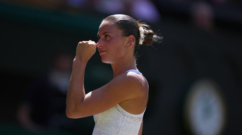 Marta Kostyuk of Ukraine celebrates a point against Jasmine Paolini of Italy, in their quarter-final women's singles match at the Wimbledon Tennis Championships in London, Wednesday, July 8, 2026. (AP Photo/Brian Inganga)