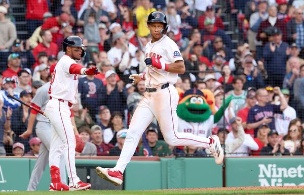 Boston Red Sox's Kristian Campbell, right, scores during the eighth inning of a baseball game against the St. Louis Cardinals, Friday, April 4, 2025, in Boston. (AP Photo/Mark Stockwell)