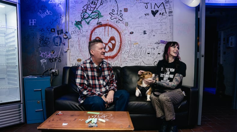 Greg Green, general manager, and Elena de Soto, talent buyer and photographer at the Masquerade music venue in Underground Atlanta, sit with Elena's corgi who is lovingly known as "Punk Rock Milo" by his 10,000+ followers on Instagram, on Friday, March 8, 2024. (Olivia Bowdoin for the AJC).