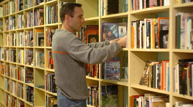 051228 Åtlanta Ga: Jeff McCord in his book store, Bound to be Read Books, which opened in mid-September is sorting through books. Dec 28, 2005 (Renee' Hannans Henry/Staff) Jeff McCord opened Bound to Be Read bookstore in 2005.