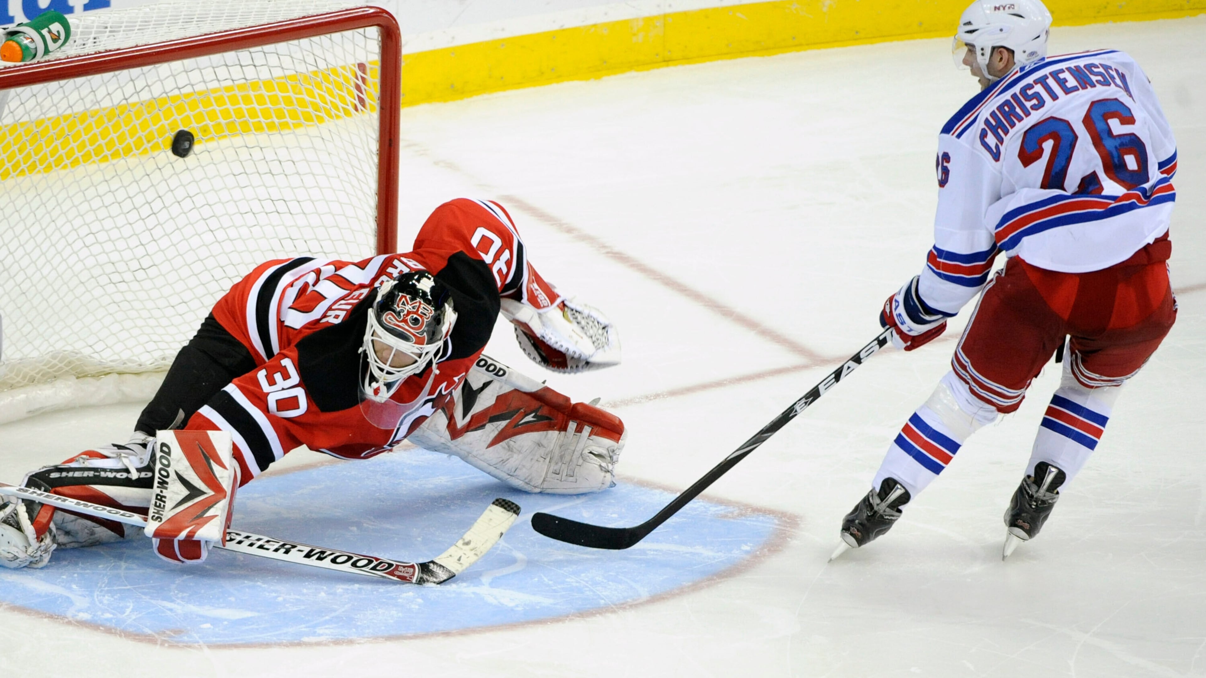 FILE - New York Rangers' Erik Christensen, right, scores a goal against New Jersey Devils goaltender Martin Brodeur during the shootout of an NHL hockey game March 25, 2010 in Newark, N.J. (AP Photo/Bill Kostroun, File)