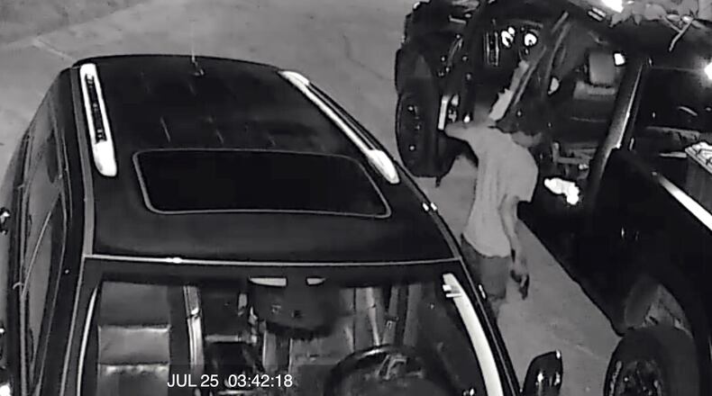 Surveillance footage from a Cherokee County home shows a man stealing a handgun from a pickup truck overnight. Deputies said four firearms were stolen after thieves broke into at least 18 vehicles in three subdivisions.