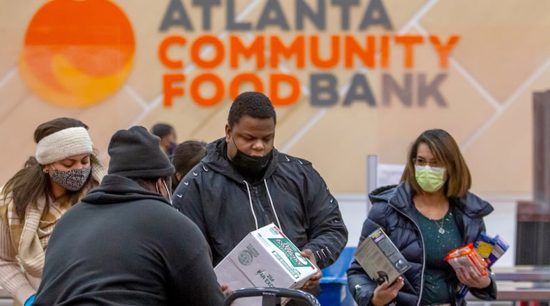Hunger Action volunteers sort food into their appropriate boxes at the Atlanta Community Food Bank Thursday, 23, 2021.   STEVE SCHAEFER FOR THE ATLANTA JOURNAL-CONSTITUTION