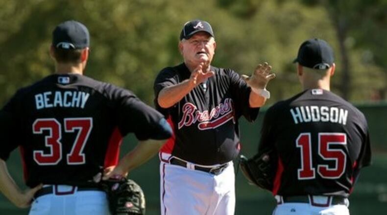 Former Braves third base coach Jimy Williams works with pitchers Brandon Beachy and Tim Hudson during spring training in 2011.