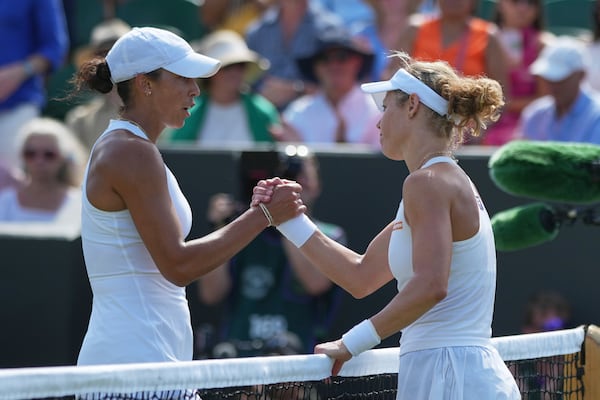 Laura Siegemund of Germany, right, greets Madison Keys of the U.S. at the net after winning their women's singles third round match at the Wimbledon Tennis Championships in London, Friday, July 4, 2025. (AP Photo/Alastair Grant)