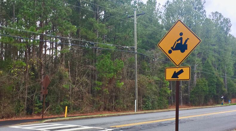 Golf carts and bicycles in Peachtree City must come to a complete stop before crossing a street, regardless of whether a stop sign is present. Jill Howard Church for the AJC