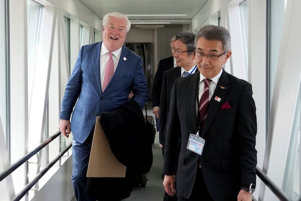 U.S. Ambassador to Japan George Glass, left, is escorted by Victor Osumi, right, president of Japan Operations of Delta, upon his arrival at Haneda Airport in Tokyo Friday, April 18, 2025. (Kazuhiro Nogi/Pool Photo via AP)