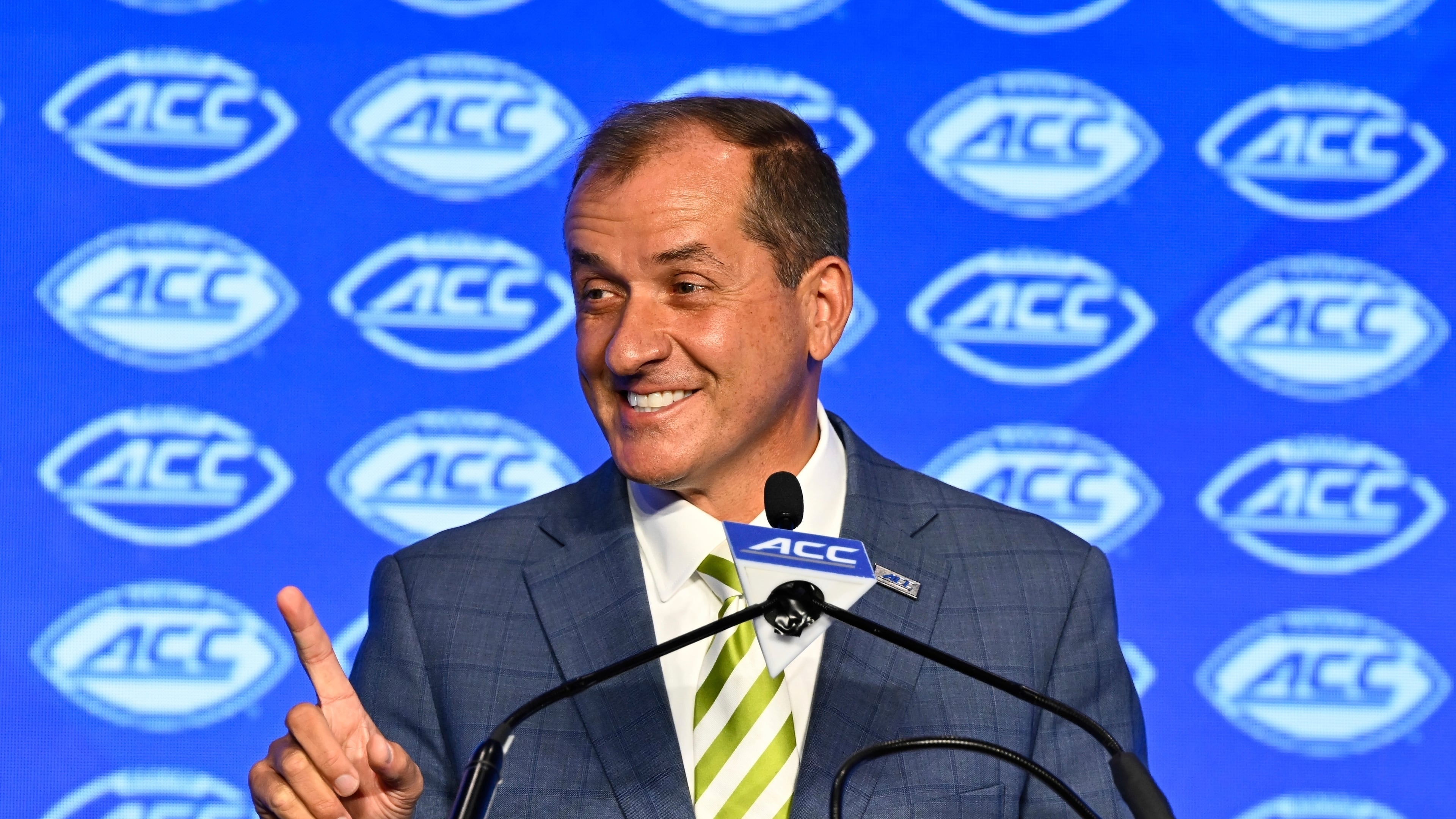 FILE - Atlantic Coast Conference commissioner Jim Phillips smiles during an NCAA college football news conference at the ACC media days, July 22, 2024, in Charlotte, N.C. (AP Photo/Matt Kelley, File)