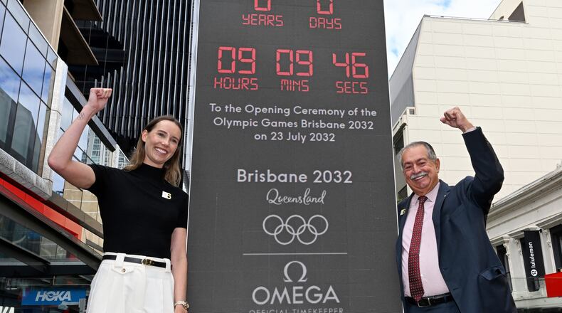 Australian Olympian Emma McKeon, left, and Brisbane 2032 Organising Committee President Andrew Liveris pose at the unveiling of the count-down clock marking six years until the Brisbane 2032 Olympics, in Brisbane, Australia, Thursday, July 23, 2026. (Darren England/AAP Image via AP)