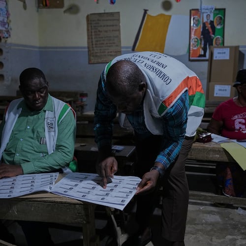 Officials count votes at a polling station in the Yopougon suburb of Abidjan, Ivory Coast, Saturday, Oct. 25, 2025, as polls close during the presidential elections. (AP Photo/Misper Apawu)