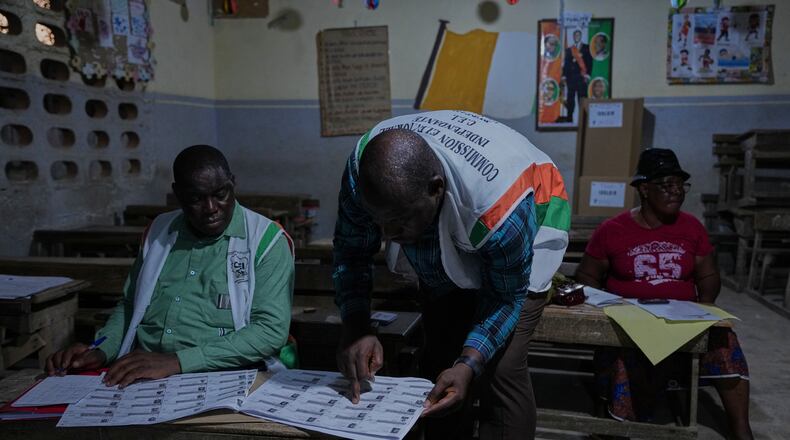 Officials count votes at a polling station in the Yopougon suburb of Abidjan, Ivory Coast, Saturday, Oct. 25, 2025, as polls close during the presidential elections. (AP Photo/Misper Apawu)