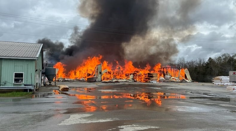 This photo provided by the Maine Department of Public Safety shows flames from a large fire at Robbins Lumber in Searsmont, Maine on Friday, May 15, 2026 (Maine Department of Public Safety via AP)