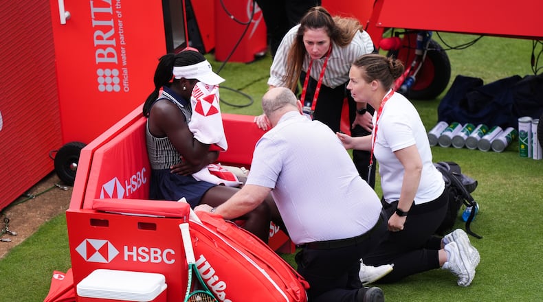 Victoria Mboko, left, of Canada retires injured during her match against Karolina Pliskova of Czech Republic on day three of the Queen's Club tennis championships in London, Wednesday, June 10, 2026. (Ben Whitley/PA via AP)
