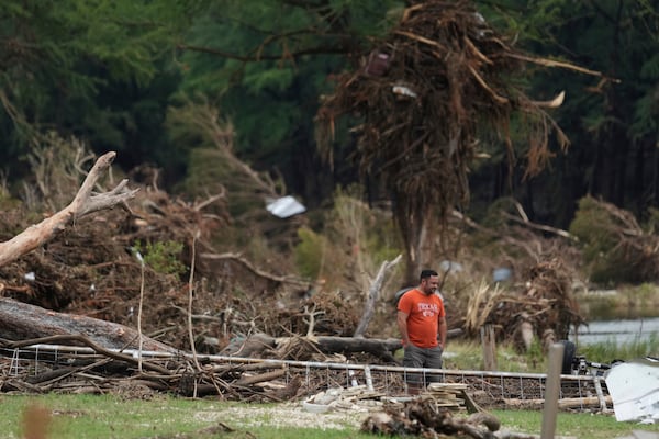 A man surveys debris and flood damage along the Guadalupe River, Sunday, July 13, 2025, in Kerrville, Texas. (AP Photo/Eric Gay)