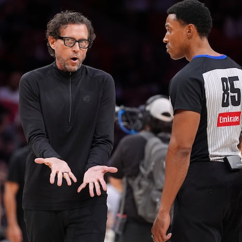 Atlanta Hawks head coach Quin Snyder, center, talks with referee Robert Hussey during the first half of an NBA basketball game against the Miami Heat, Sunday, April 12, 2026, in Miami. (Rebecca Blackwell/AP)