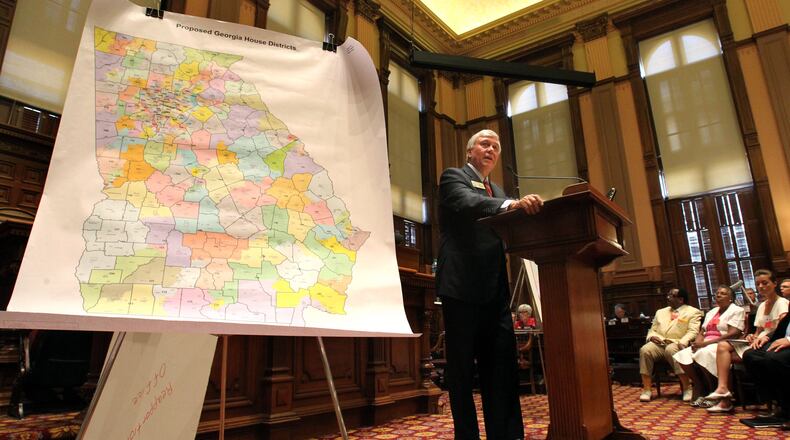 Competitive districts – in which either a Republican or a Democrat has a shot at winning – are an endangered species in Georgia. Here, Rep. Roger Lane, R-Darien, unveils the proposed map of House districts in 2011. AJC FILE